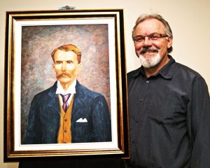 Ralph Tanchak with his portrait of Samuel Jacob Jackson